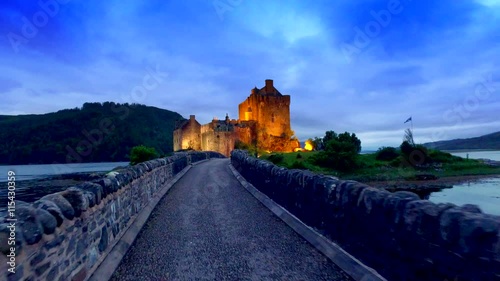 Footpath to the beautiful illuminated Eilean Donan Castle at sunset in Scotland