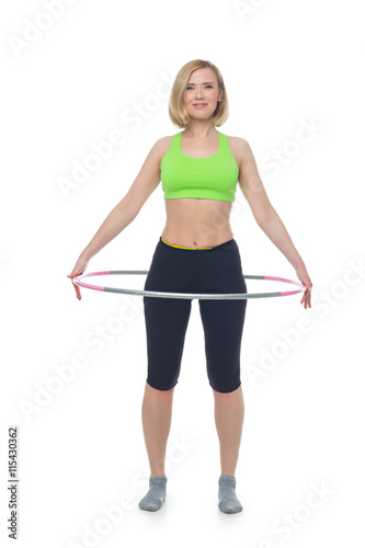 Beautiful woman doing sport exercise with hula hoop