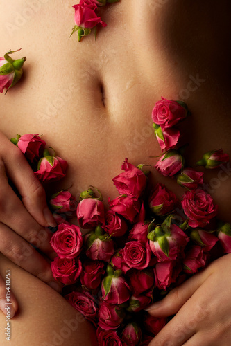 Sensual female body with roses flowers
