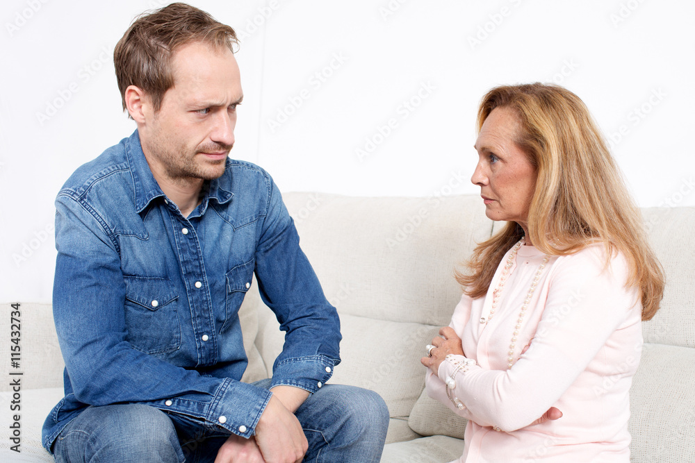Younger man with elderly woman with negative emotions