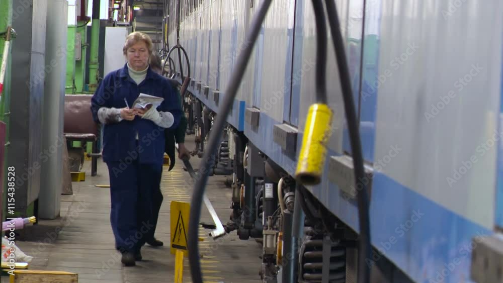 Subway Depot. Two Female Workers Carry Out Diagnostics of Rolling Stock Subway Depot. Two Female Workers Carry Out Diagnostics of Rolling Stock