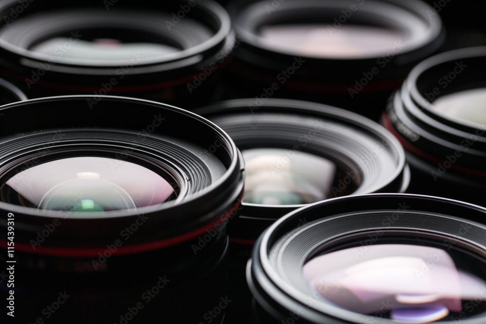 Modern camera lenses with reflections, low key image Modern camera lenses with reflections, low key image