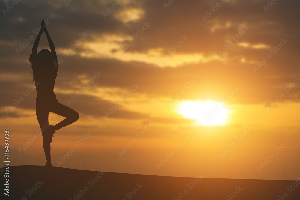 Silhouette of a beautiful Yoga woman in the morning.vintage colo