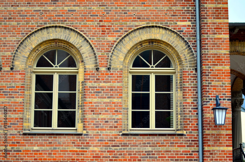 two old windows with bricks and arch