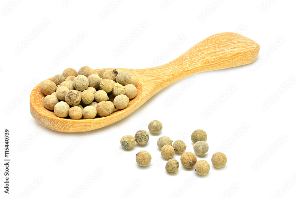 White peppers and wooden spoon on white background White peppers and wooden spoon on white background