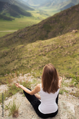 Young Woman Outdoor Meditation. Sitting on the Mountain.