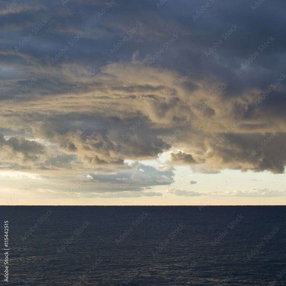 Dark cumulus clouds hovering over the sea Dark cumulus clouds hovering over the sea