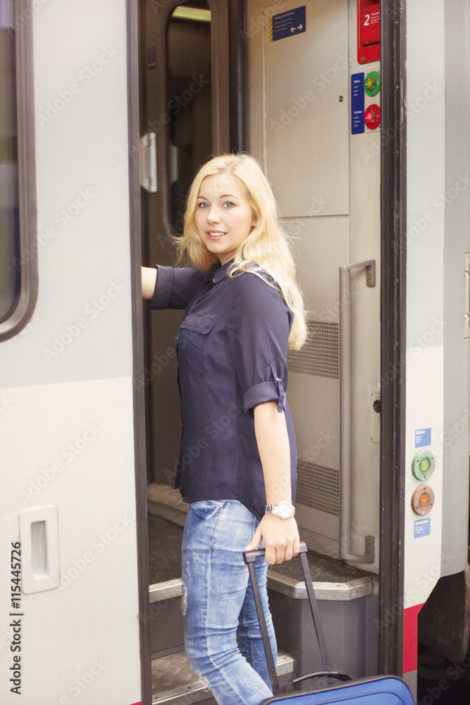 Smiling woman getting on the train Smiling woman getting on the train
