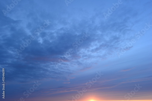 Blue cloudy sky at sunset on a summer evening
