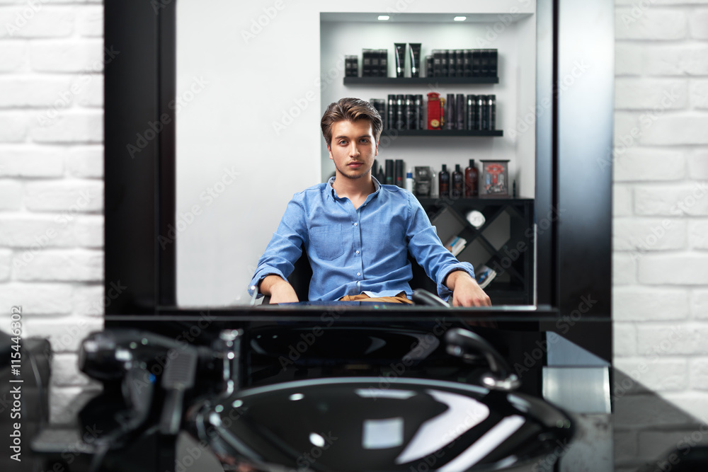 man looks at himself in the mirror Barbershop man looks at himself in the mirror Barbershop