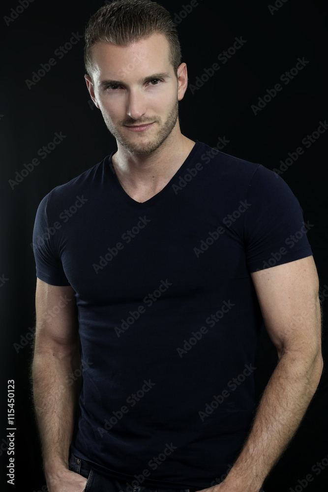 Fototapeta premium Handsome man posing over a black background