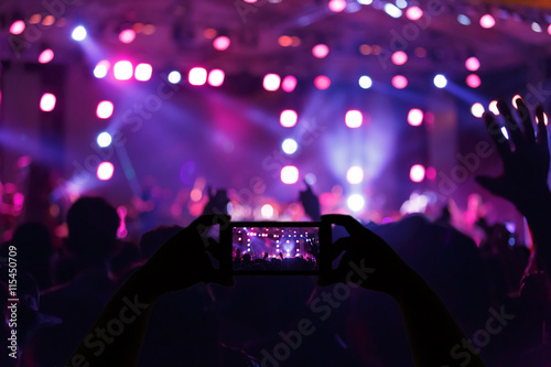 Take photo crowd in front of concert stage blurred