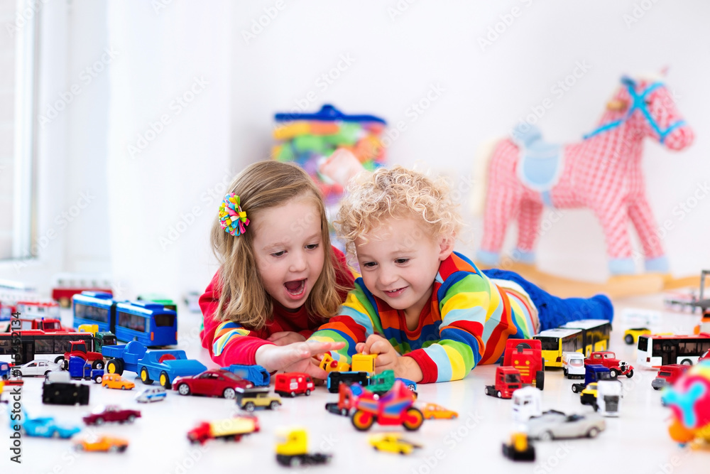 Fototapeta premium Little kids playing with toy cars