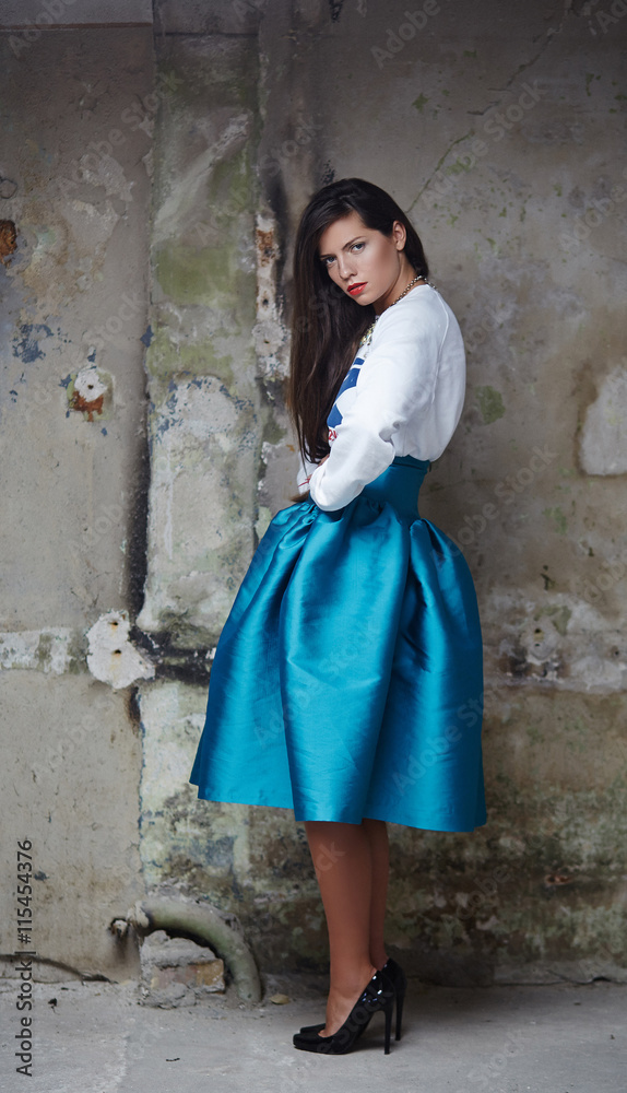 Portrait of brunette female in a blue skirt. Portrait of brunette female in a blue skirt.