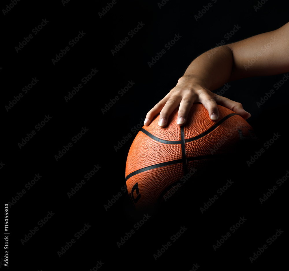 fragment of a basketball ball in a hand of the basketball player fragment of a basketball ball in a hand of the basketball player