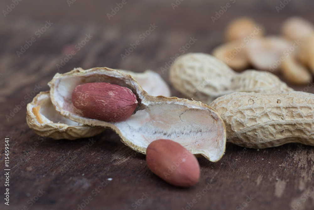 Peanuts in shells on wood background Peanuts in shells on wood background