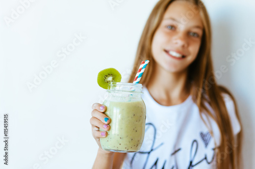 Kid girl drinking smoothie