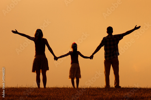 Family enjoy in sunset together.