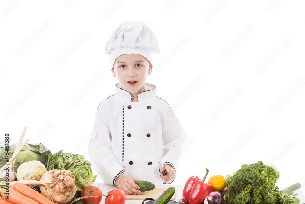 One little boy as chef cook making salad, cooking with vegetable One little boy as chef cook making salad, cooking with vegetable