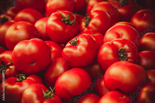 Fresh organic tomatoes at market background texture