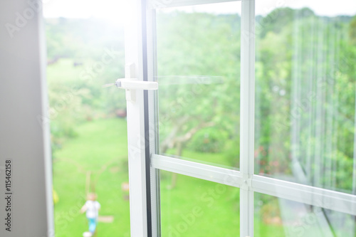 Window with view of summer backyard 