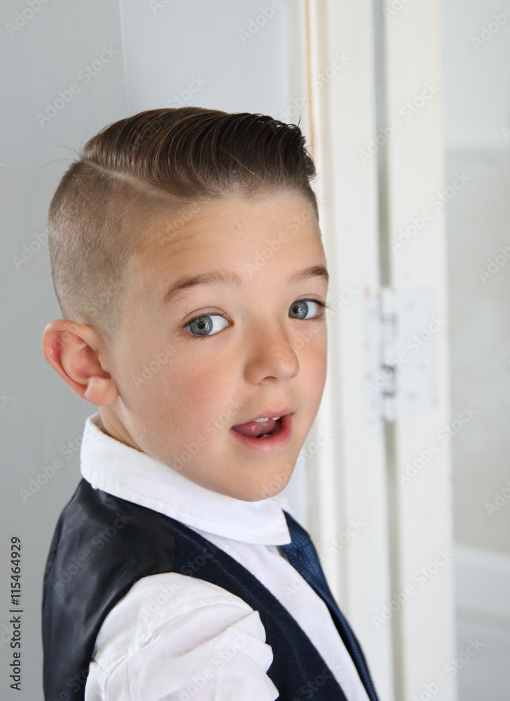 A smart young boy looking over his shoulder A smart young boy looking over his shoulder