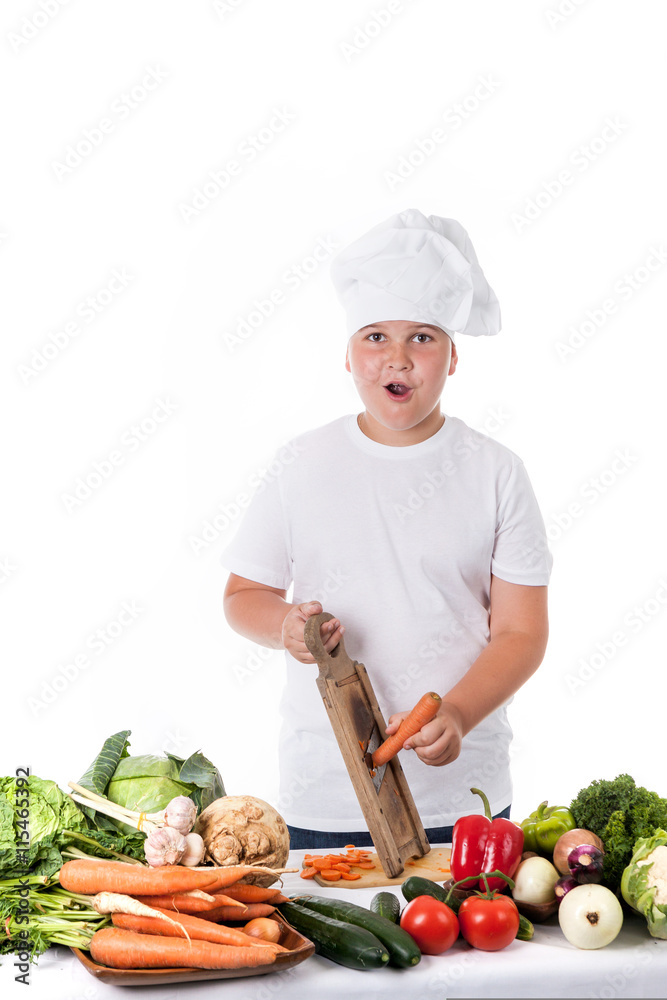 One little boy as chef cook making salad, cooking with vegetable One little boy as chef cook making salad, cooking with vegetable