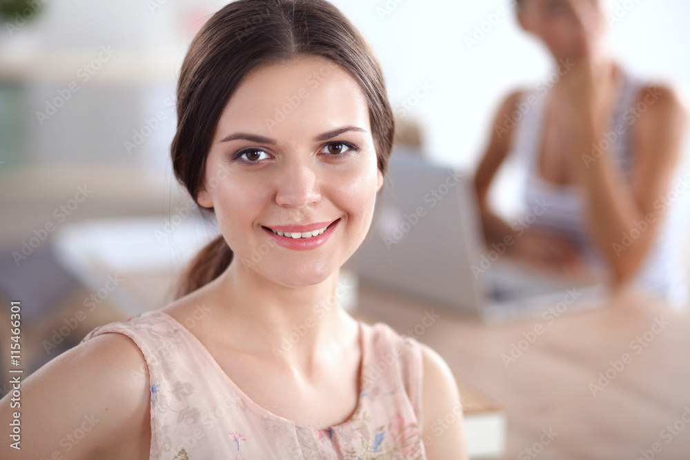 Attractive businesswoman sitting on desk in the office Attractive businesswoman sitting on desk in the office