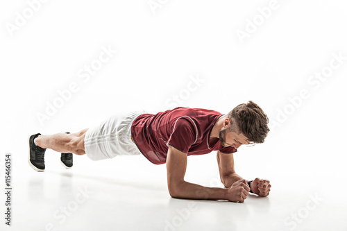 Professional male athlete exercising on flooring
