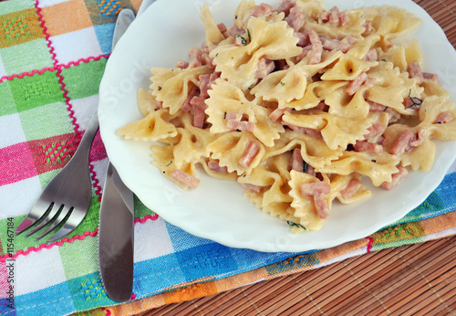 White plate of pasta carbonara with ham. Italian food.