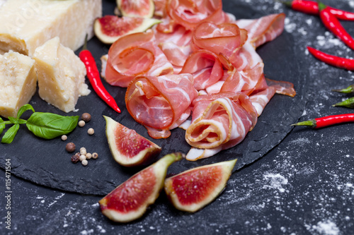 Prosciutto with figs and chili pepper, selective focus