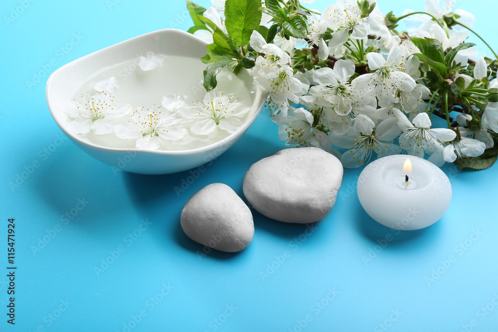 Spa treatment with blooming branch on blue background Spa treatment with blooming branch on blue background