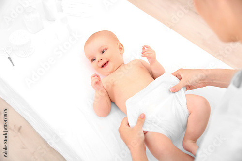 Mother changing diaper to l...