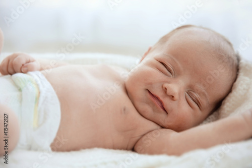 Newborn baby girl, 7 days old, sleeping on soft fluffy blanket
