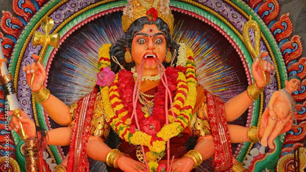 Colorful, yet terrifying sculpture of the goddess, Kali, adorned with flower leis, in a temple in Southeast Asia. Video 4k Colorful, yet terrifying sculpture of the goddess, Kali, adorned with flower leis, in a temple in Southeast Asia. Video 4k