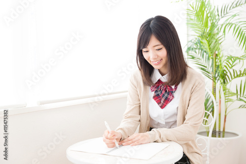 asian schoolgirl studying in the cafe