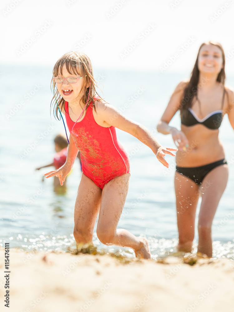 Little girl kid and woman mother in sea water. Fun Little girl kid and woman mother in sea water. Fun