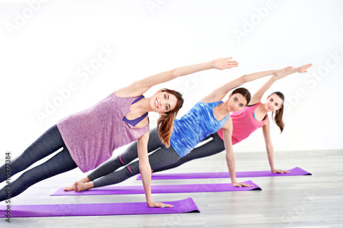 Young women doing yoga in gym