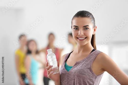 Smiling young woman holding...