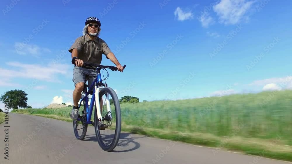 Senior man riding his mountain bike Senior man riding his mountain bike