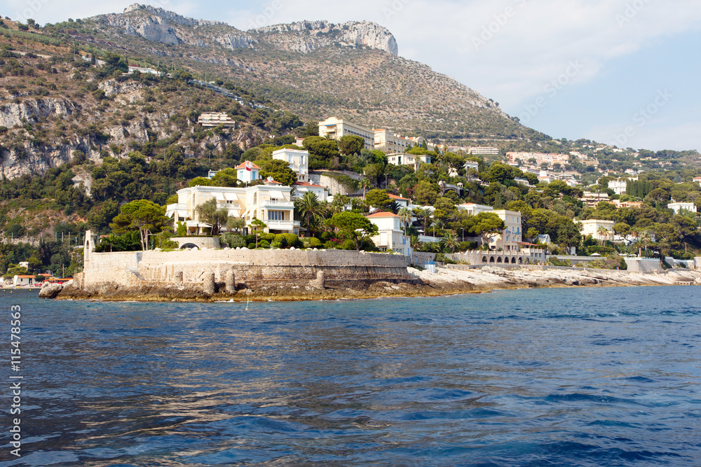 Luxury homes on the rocky Mediterranean coast of the French Riviera. Horizontal with copy space for text