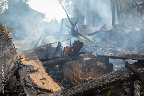 Obraz na plátně Burning and smoldering house.