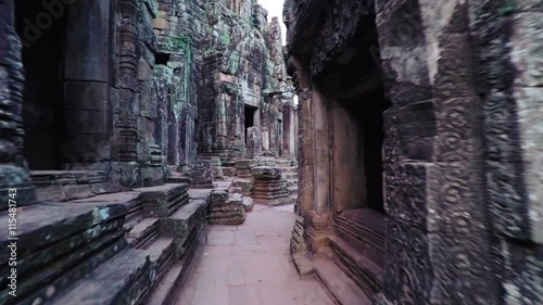 Strolling along an ancient pathway between the intricately carved stupas of Bayon Temple in Cambodia. Video 4k