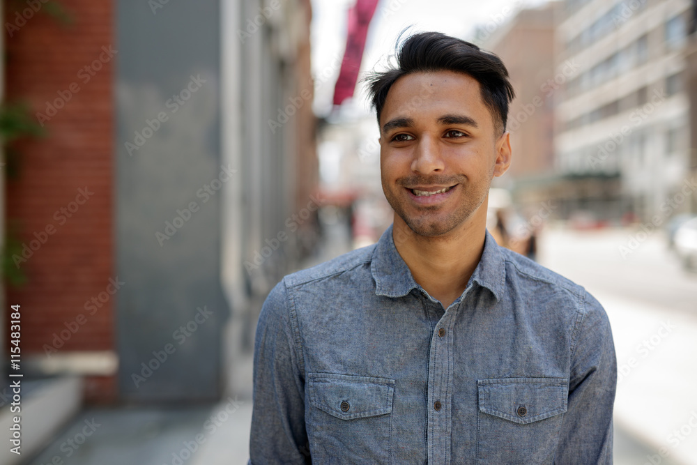 Young Indian man in city walking street Young Indian man in city walking street