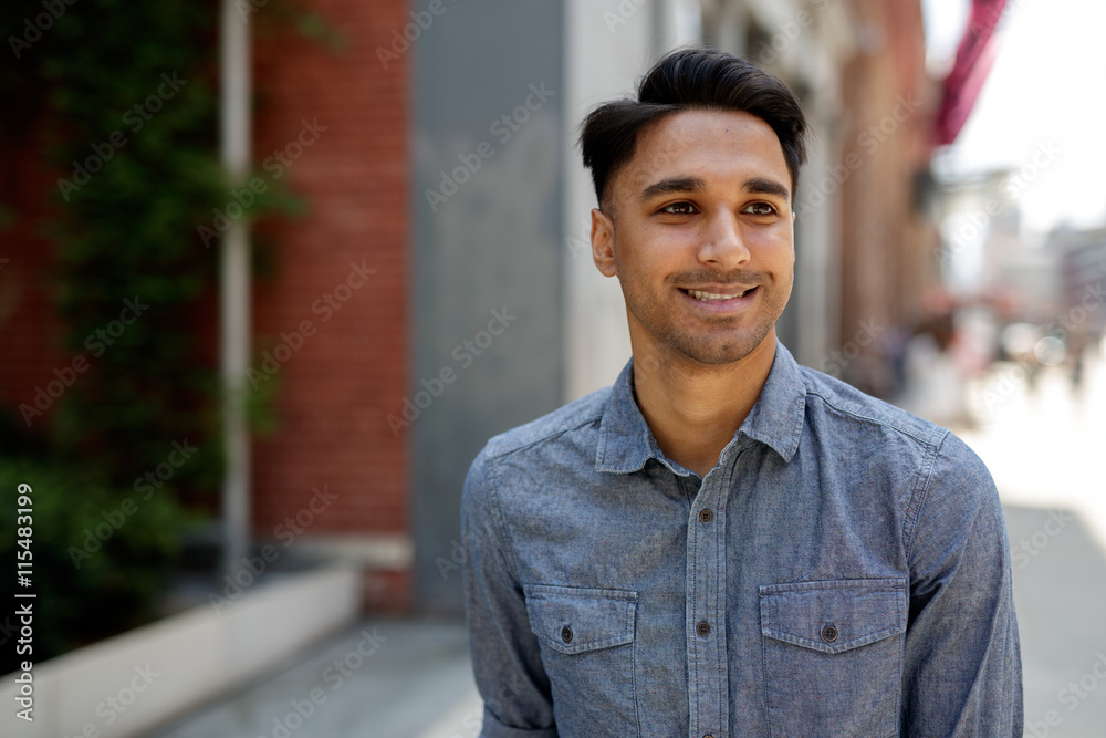 Young Indian man in city walking street Young Indian man in city walking street