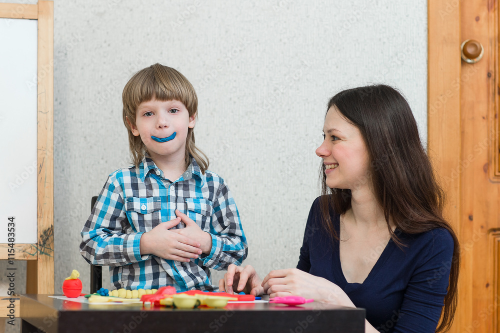 Fototapeta premium child kid boy and mother play colorful clay