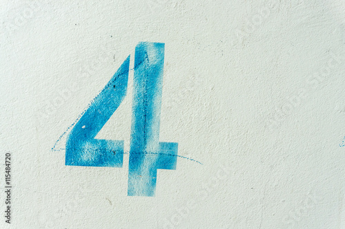 the number 4 on the dirty white wall
