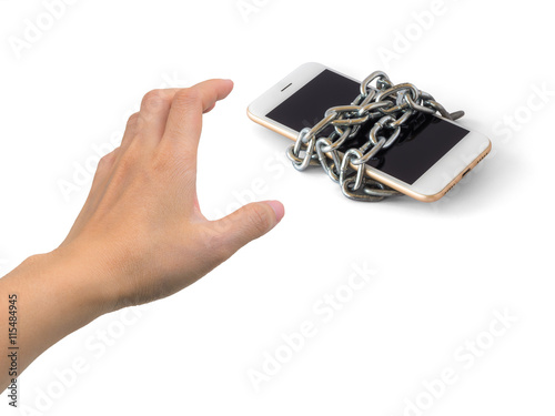 Quadro em tela Human hand trying to catch chained smart phone isolate on white background with clipping path and copy space