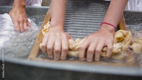 women wash using a old fashioned washboard  photo