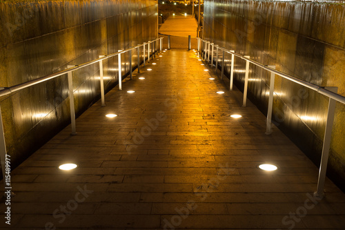 lighted walkway with a fountain on each side